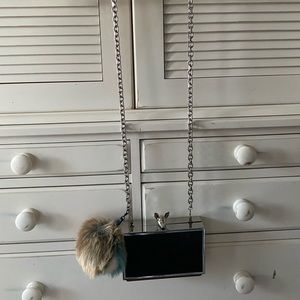 Black evening bag with detachable pompom and strap